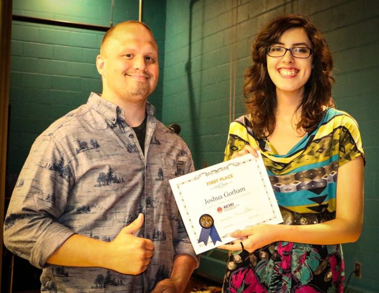 Cultural Program Coordinator Moira Villiard presents Joshua Gorham with the certificate for First Place. Photo by Ivy Vainio.