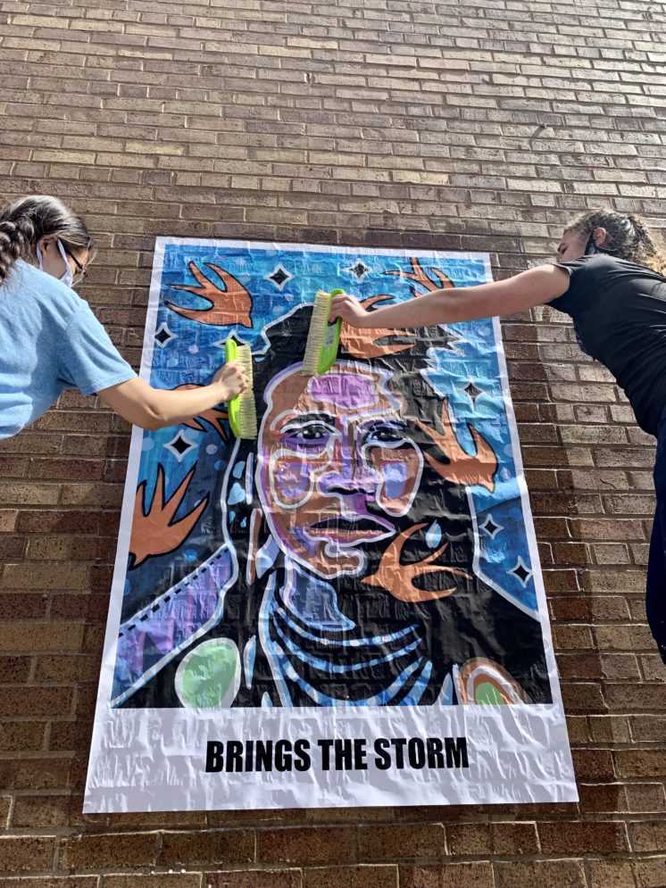 Applying the poster to the wall